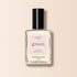 A clear glass bottle of Shell nail polish from Manucurist, with a black cap and light pink label, is displayed against a light beige background.