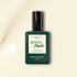 A bottle of Manucurist nail polish in the shade Shell, featuring a dark green label and black cap, is displayed on a light beige background.