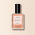 Un flacon de vernis à ongles orange Pamplemousse de Manucurist, dans une teinte orange pêche, avec un bouchon noir et une étiquette mettant en avant sa formule à séchage rapide et à la couleur intense.