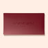 Un coffret rectangulaire fermé Holiday Rainbow Burgundy par Manucurist, avec le nom de la marque et « PARIS » embossés sur le couvercle, sur un fond beige clair.