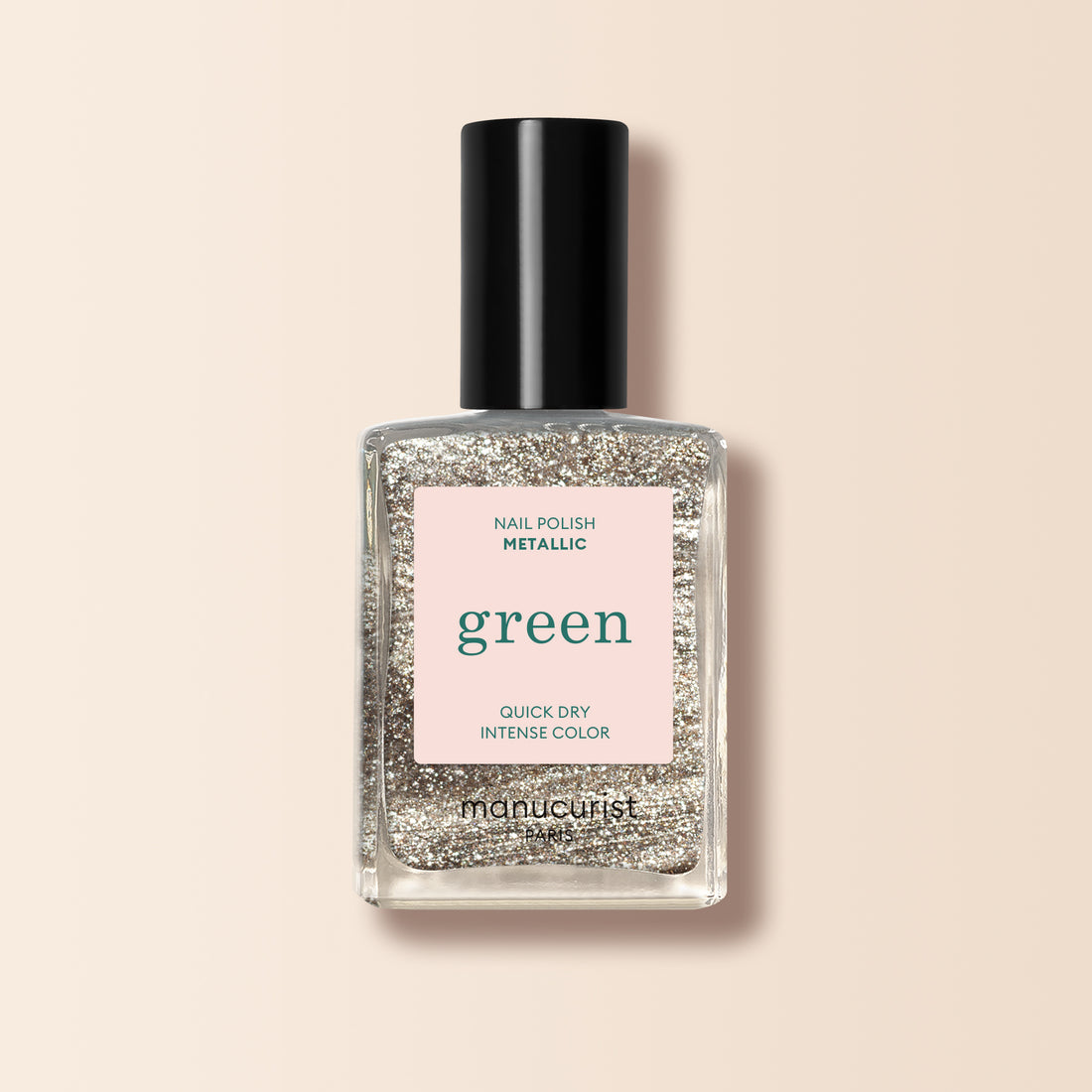 A bottle of Manucurist Metallic nail polish with metallic highlights and intense color sits on a pale pink background.