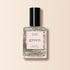 Un flacon de vernis à ongles Metallic Manucurist aux reflets métalliques et à la couleur intense est posé sur un fond rose pâle.
