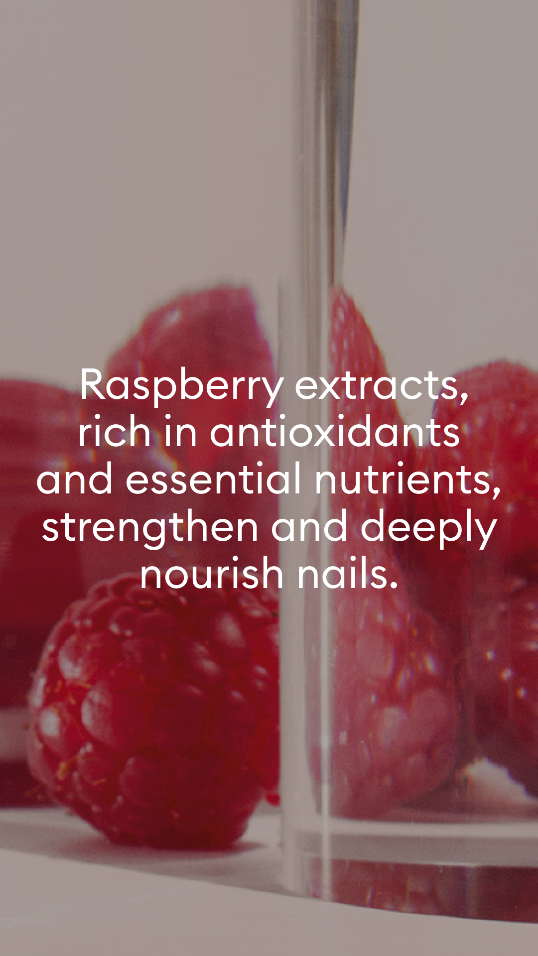 Close-up of fresh raspberries behind glass with text overlay promoting raspberry extracts for their antioxidants and nutrients that strengthen and nourish nails.