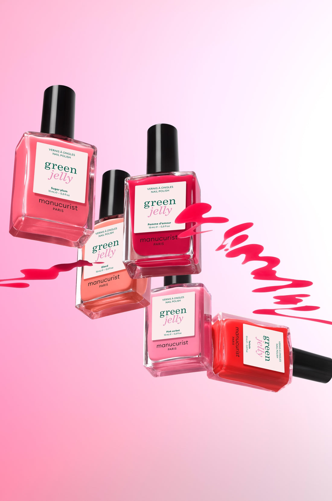 Five bottles of Manucurist Green Jelly nail polish in various pink and red shades float against a pink gradient background, with bright pink polish swirled between them.