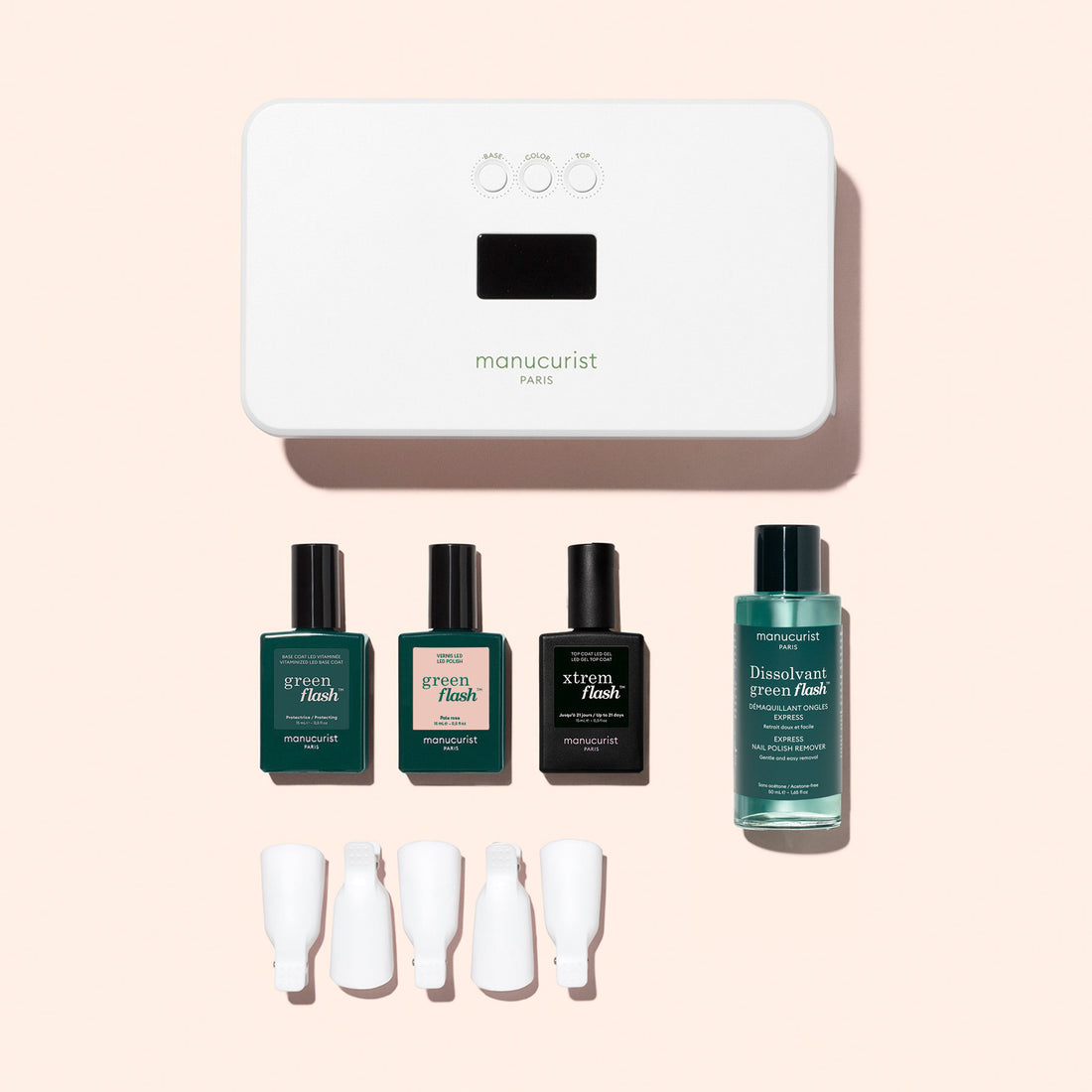 Un kit découverte Manucurist de vernis semi-permanent LED Soap Nails, comprenant une lampe LED, trois petits flacons de vernis semi-permanent longue tenue, un flacon de dissolvant et quatre pinces à ongles en silicone.