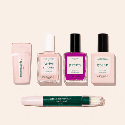Five Manucurist French Color Kit products are displayed on a light beige background: a nail buffer, two pale pink polishes, one bright fuchsia polish, and a green-capped corrector pen for flawless nails.
