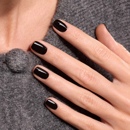 A hand with neatly manicured nails painted in Manucurist&