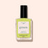A clear glass bottle of bright anise green nail polish called Lime by Manucurist, with a black cap, is placed on a light beige background.