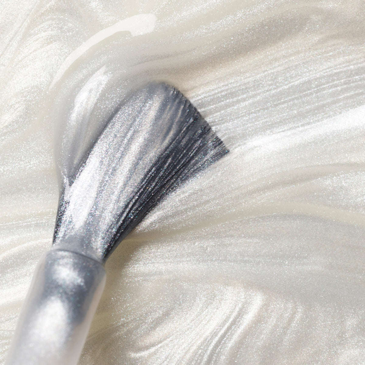 A close-up of a brush applying Manucurist&