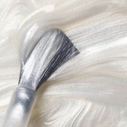 A close-up of a brush applying Manucurist&