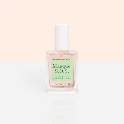 A clear glass bottle of Manucurist S.O.S. Nail Mask, a hydrating nail treatment with a white cap and light pink liquid, sits against a pastel peach and white background.