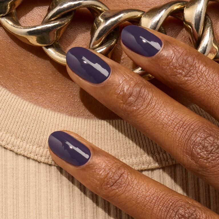 A close-up of a hand with short, oval nails painted in Manucurist&