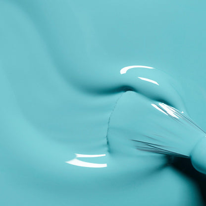 A close-up of a paintbrush applying Manucurist&