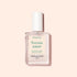 A clear rectangular bottle of Manucurist Bitter Polish with a white cap rests on a pale pink background. Its cream label with green and beige text highlights nail care benefits, helping prevent nail biting.