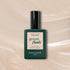 Un flacon de vernis à ongles Pearlescent de Manucurist, avec un bouchon et une étiquette vert foncé, repose sur un fond gel beige scintillant. L’étiquette indique : « green flash, séchage instantané, tenue extra longue, manucurist Paris. »