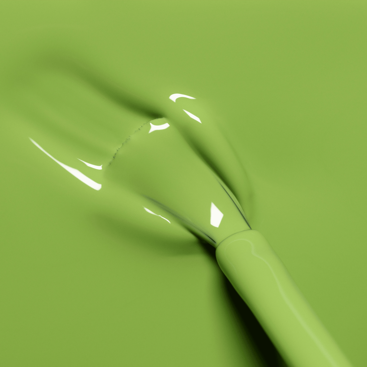 A close-up of a nail polish brush spreading glossy, light green Sweet Pea by Manucurist on a smooth surface. The thick, shiny polish reflects light softly.