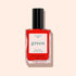 A bottle of Manucurist Lava nail polish, a fiery red shade with warm orange undertones, black cap, and white label, shown on a light beige background.