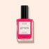 A bottle of Manucurist Neon Pink nail polish with a semi-matte finish and black cap, labeled green and quick dry intense color, sits against a pale peach background—ideal for vibrant summer nails.