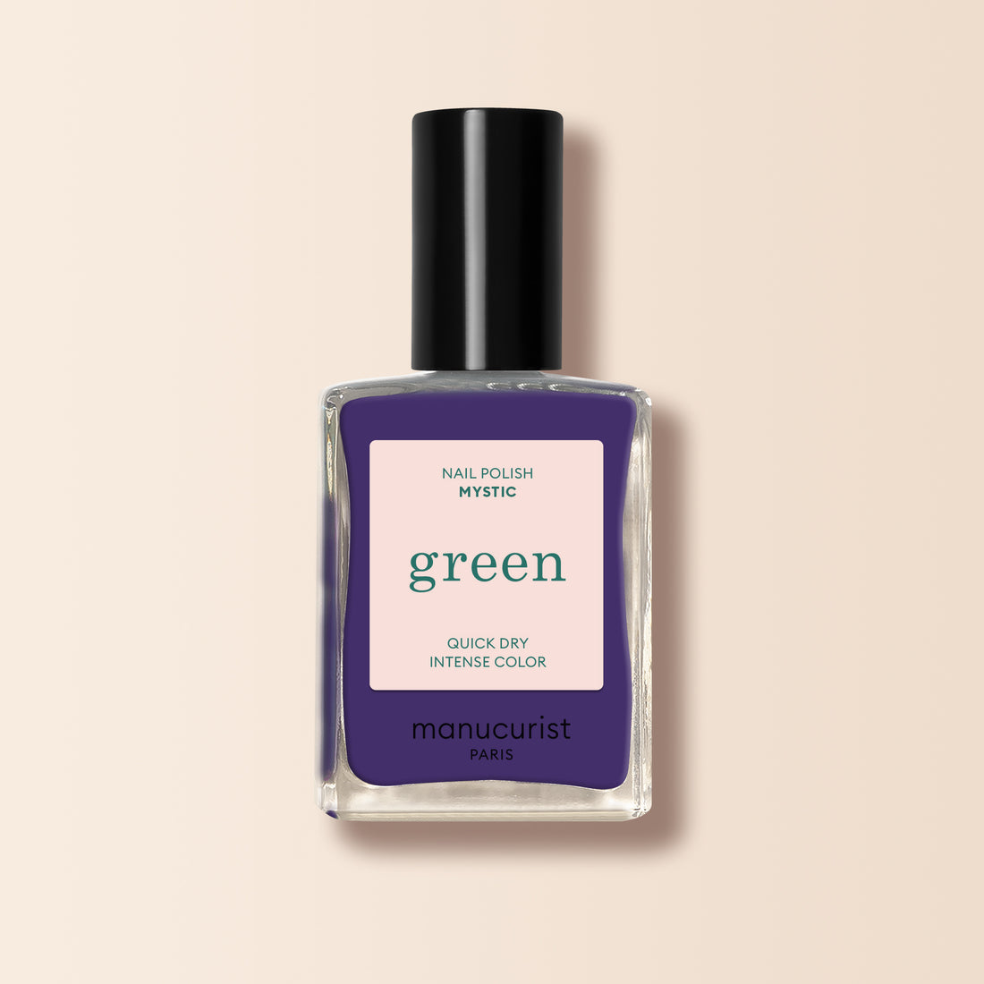 A bottle of Manucurist Mystic nail polish, featuring intense purple color, a black cap, and a label reading "NAIL POLISH MYSTIC green QUICK DRY INTENSE COLOR" and "manucurist PARIS" on a light background.