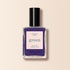 A bottle of Manucurist Mystic nail polish, featuring intense purple color, a black cap, and a label reading "NAIL POLISH MYSTIC green QUICK DRY INTENSE COLOR" and "manucurist PARIS" on a light background.