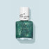 A bottle of Marius the Diplodocus kids nail polish by Manucurist, with natural ingredients, a white cap labeled petite manucurist PARIS, and a dinosaur line drawing on the bottle, set against a pale blue background.