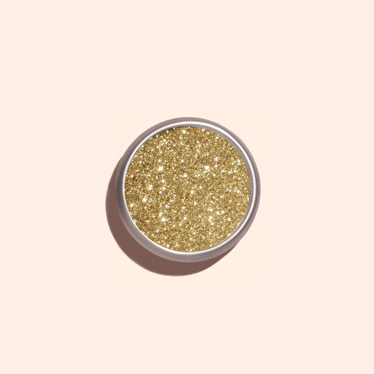 A round Manucurist Golden Chrome Powder container, viewed from above on a pale beige background, ideal for achieving a dazzling chrome finish.