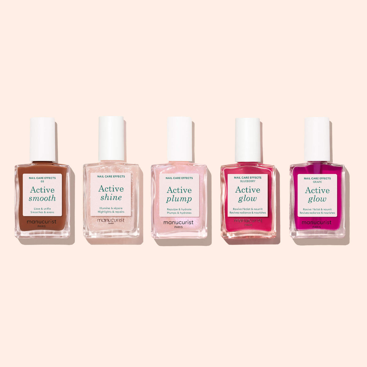 Five bottles of Manucurist nail care, including Active Smooth 03, are arranged in a row on a light beige background. Each bottle features a white cap and differently colored liquid, with labels: Active Smooth, Shine, Plump, Glow, and Glow.