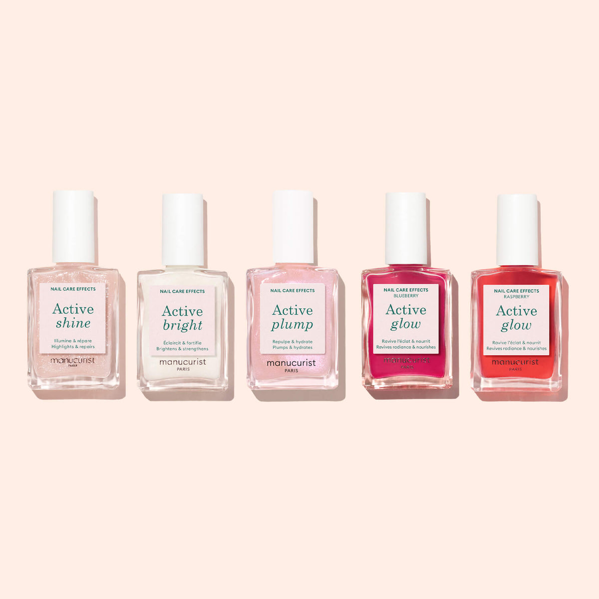 Five bottles of Manucurist nail care polish—including Active™ Shine Opal, Active Bright, Active Plump, and two bottles of Active Glow—are arranged in a row on a light pink background. These plant-based formulas are designed to strengthen nails while enhancing their natural beauty.