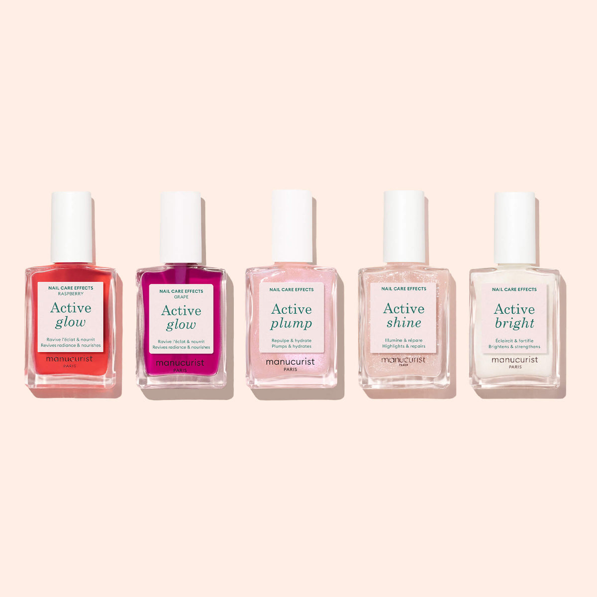 Five bottles of Manucurist plant-based nail care products, including Active™ Glow Raspberry, Active Plump, Active Shine, and Active Bright, are arranged in a row against a light pink background, highlighting their commitment to nail nourishment.