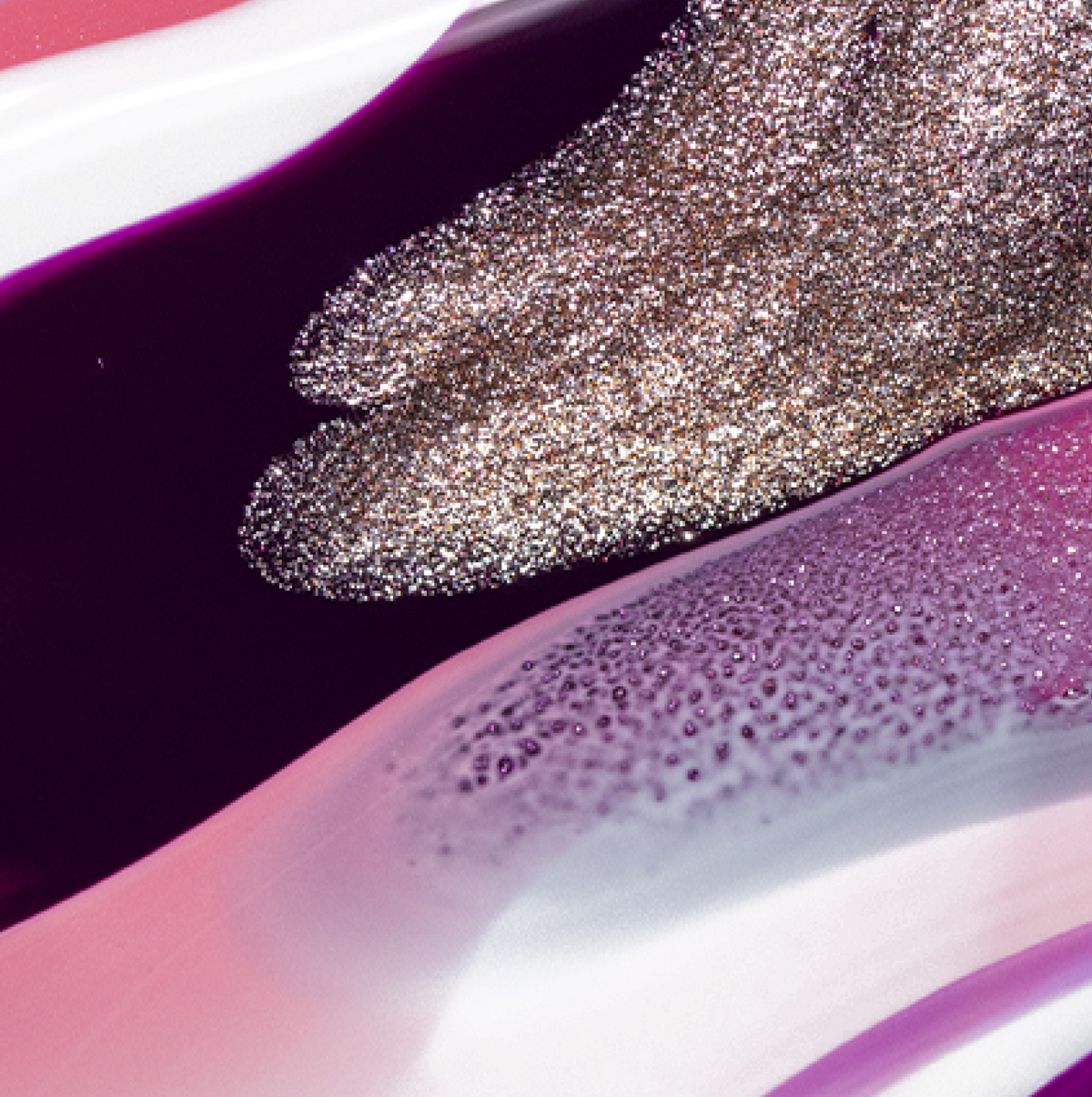 Swirls of metallic silver glitter and glossy purple, pink, and white nail polish create an abstract, textured pattern with shimmering and smooth sections.