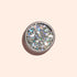 A round container of Manucurist Biodegradable Holo Glitter, seen from above on a light beige background with a soft shadow—ideal for adding eco-friendly sparkle to your next nail art design.
