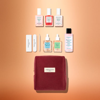 The Manucurist Active™ Starter Kit Gift Set features a chic burgundy manicure kit complete with nail polishes, remover, oils, files, and essential tools—all artfully arranged on a peach background. With the Manucurist label proudly displayed on the bag, this set is the perfect way to elevate your manicure routine and makes an ideal holiday gift for anyone who loves beautiful nails.