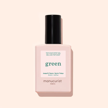 A bottle of Manucurist Green Sunshine Top Coat comes in a pale pink rectangular bottle with a black cap and white label, offering a gel-effect finish with its plant-based formula.