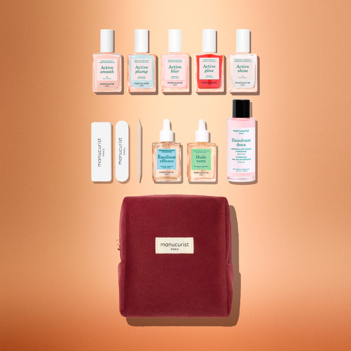 Introducing the Manucurist Active™ Super Starter Gift Set—a burgundy manicure kit featuring nail polishes, nail care bottles, sticks, a nail file, and remover, all artfully arranged on a peach background. This set is perfect for upgrading your at-home manicure routine or gifting to anyone who appreciates beautiful nails.