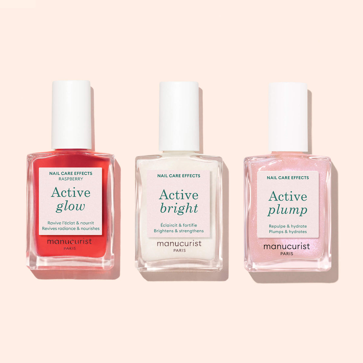 Three bottles of Manucurist nail care—Active™ Glow Raspberry (red), Active Bright (clear), and Active Plump (pink)—are displayed side by side on a light background, highlighting a plant-based approach to nail nourishment.