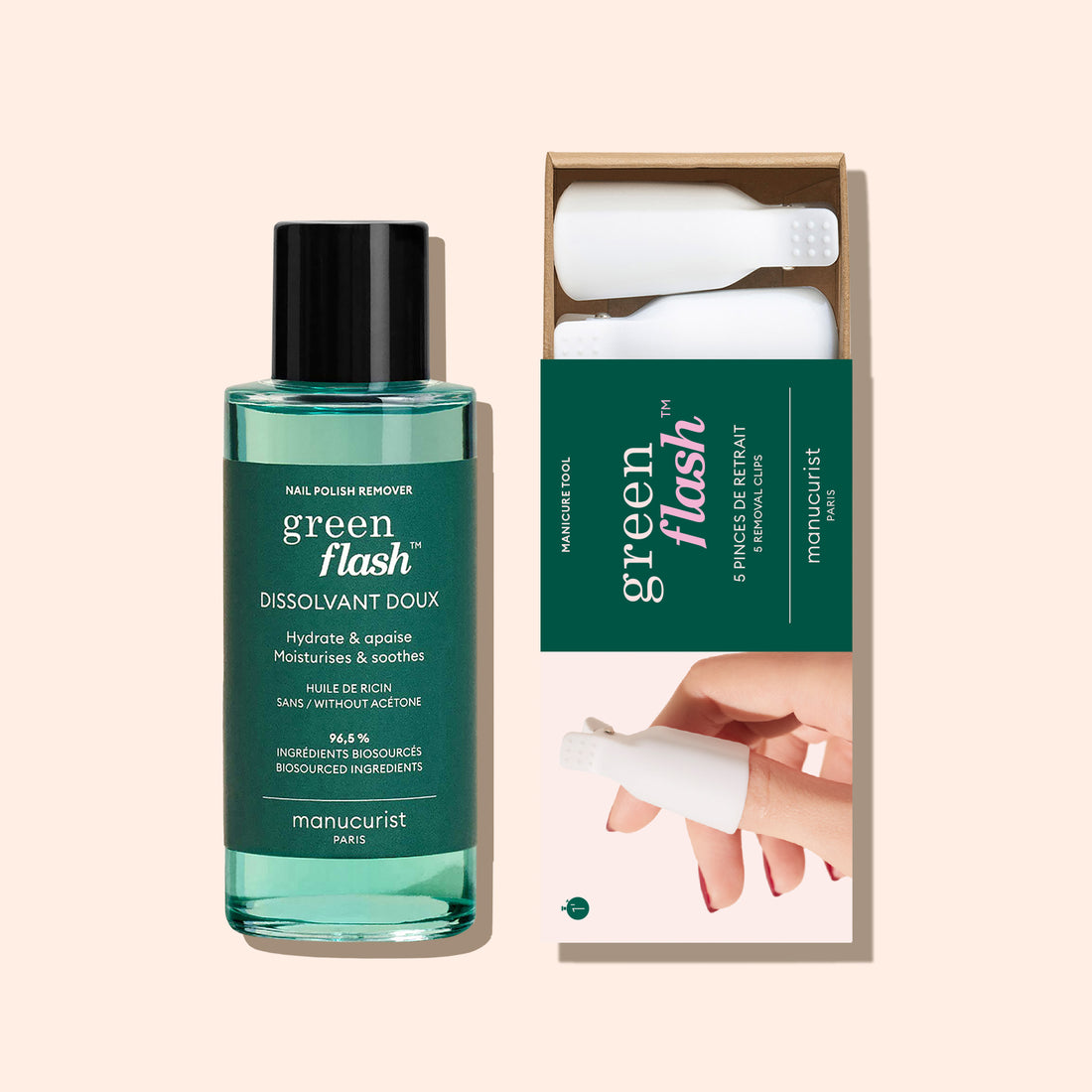 A bottle of Manucurist-us Green Flash™ Remover  Clips Duo stands beside an open box with five reusable fingertip clips, each featuring a white textured cap. The background is a soft beige color.