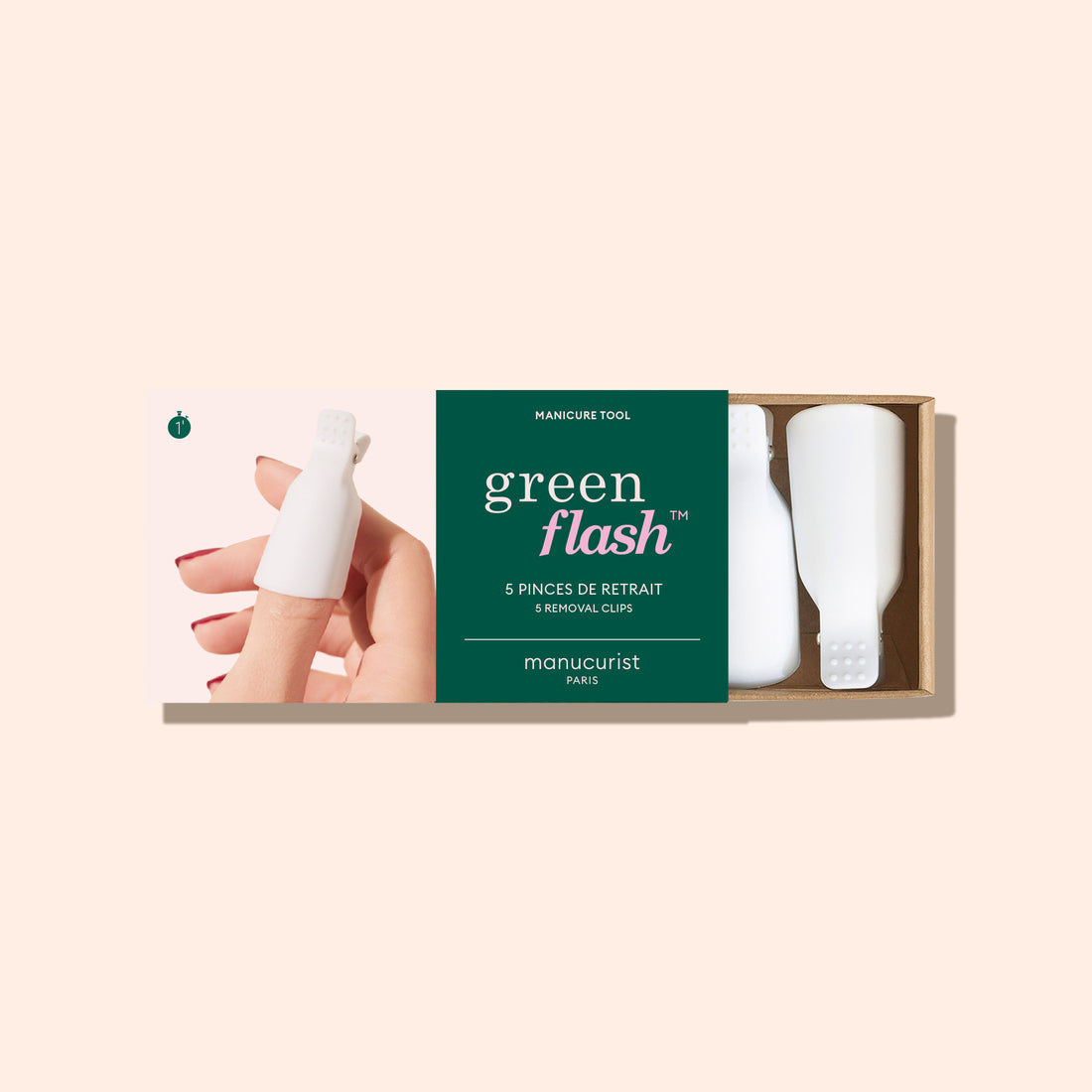 A box of Manucurist-us Green Flash™ Remover Clips is displayed, showing an image of fingers with white clips for gentle nail polish removal and three clips beside the packaging on a light beige background.