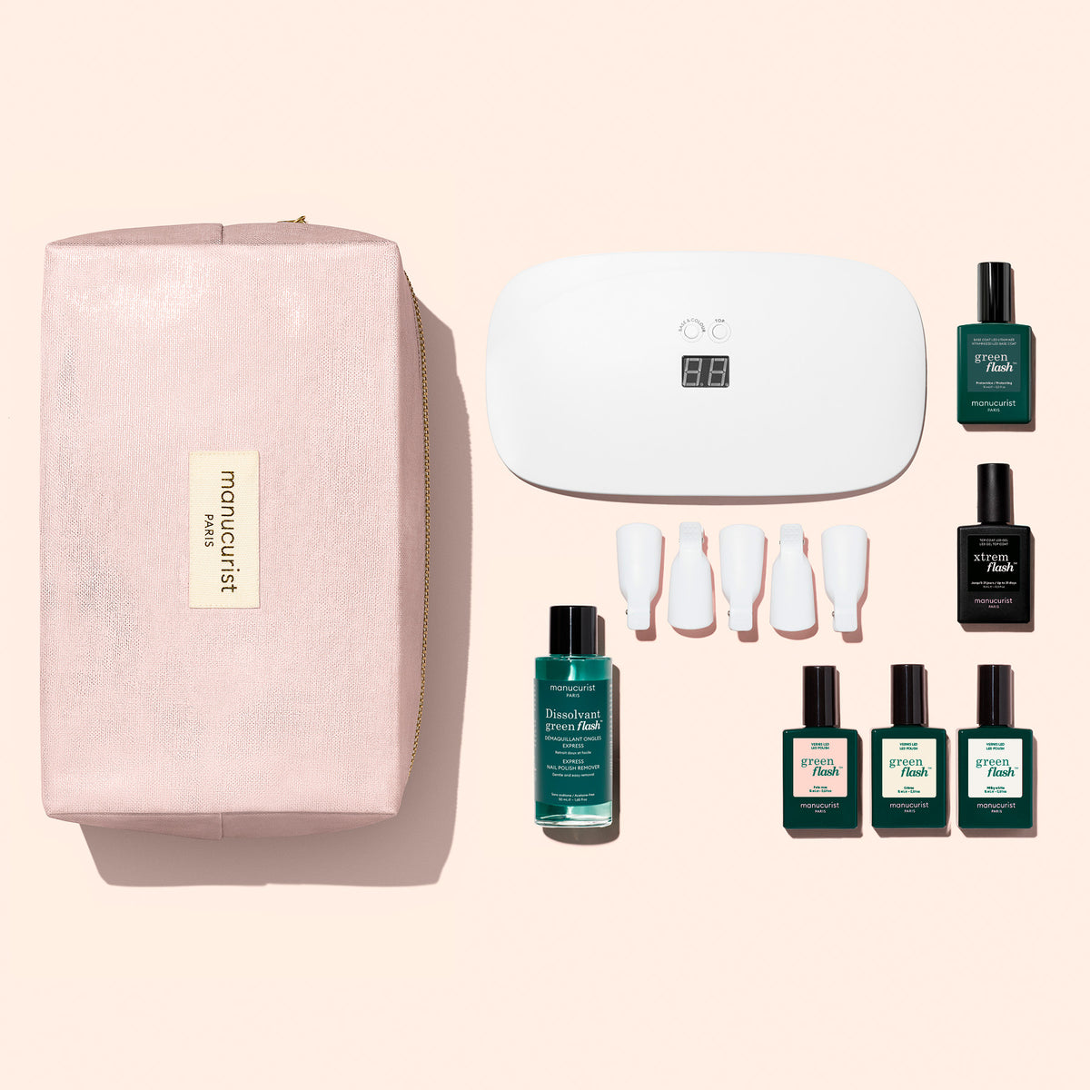 A Manucurist Starter Kit - Soap Nails LED Gel Polish including a white LED lamp, five bottles for an ultra-glossy manicure, a bottle of remover, a set of finger clips, and a zippered storage pouch.