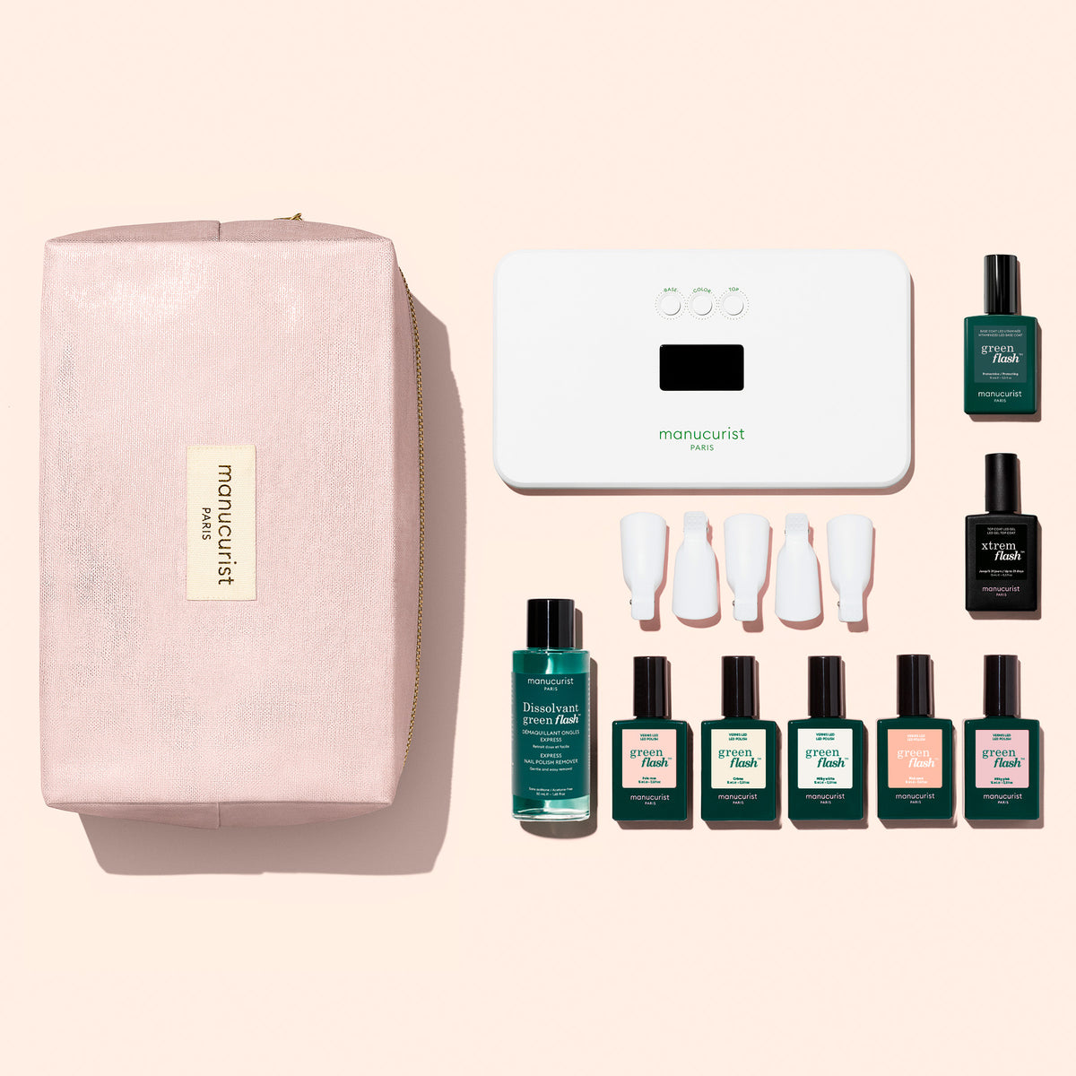 Le Super Starter Kit Manucurist de vernis semi-permanent LED Soap Nails comprend une pochette zippée rose clair, une lampe LED blanche, du dissolvant, cinq vernis colorés, une Base Coat vitaminée, un Top Coat et cinq pinces à ongles blanches pour une manucure ultra-brillante.