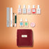 The Manucurist Active™ Super Ultimate Gift Set is perfect for your active manicure routine, featuring files, a cuticle tool, nail polishes, gentle nail remover, cuticle oils, balm, and a red velvet pouch—all arranged neatly on a peach-colored background. Ideal as a thoughtful holiday gift.