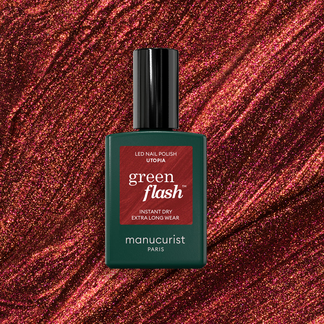 A bottle of Manucurist Utopia gel polish stands against a sparkling, deep red glittery background. The bottle is dark green with a black cap and red label.