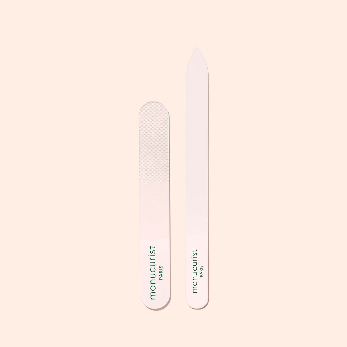 Two Manucurist-us Glass Polishers are displayed on a light beige background—one rounded, one pointed. Both feature the brand&
