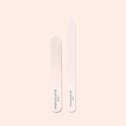 Two Manucurist-us Glass Polishers are displayed on a light beige background—one rounded, one pointed. Both feature the brand&