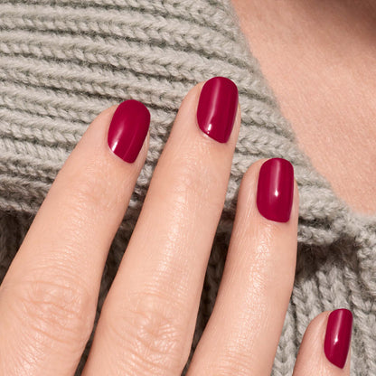 A hand with neatly manicured nails painted in Manucurist&