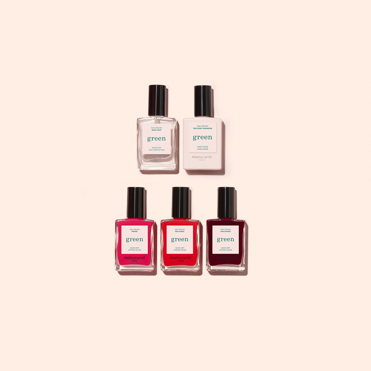 Five nail polish bottles from the Welcome kit Green by Manucurist-test are arranged in two rows on a beige background: two clear bottles above three in pink and red shades.