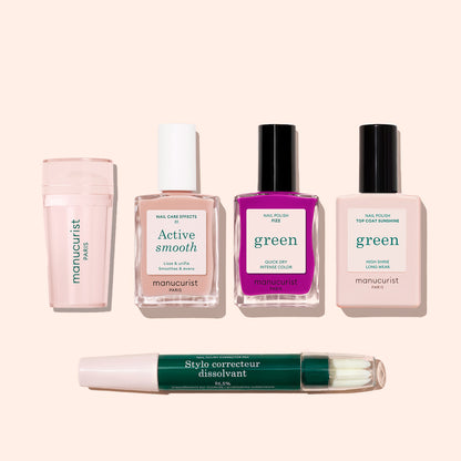 The Manucurist French Color Kit, featuring a cuticle remover, nail care bottle, bright and pale pink green-labeled polishes, and a dual-ended corrector pen, is displayed on a light beige background.