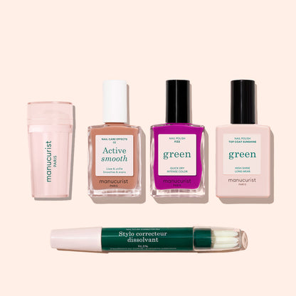 Five Manucurist French Color Kit manicure products—cuticle remover, nail care polish, bright pink polish, clear top coat, and a double-ended nail polish corrector pen—are arranged on a light beige background.
