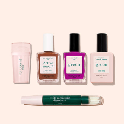 Five items from the Manucurist French Color Kit are arranged on a light background: a pink buffer, brown Active Smooth polish, purple polish, light pink top coat, and a dual-ended green nail polish corrector pen.