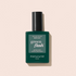 A bottle of Manucurist Green Flash™ Base Coat with a dark green label and black cap is shown against a light beige background.