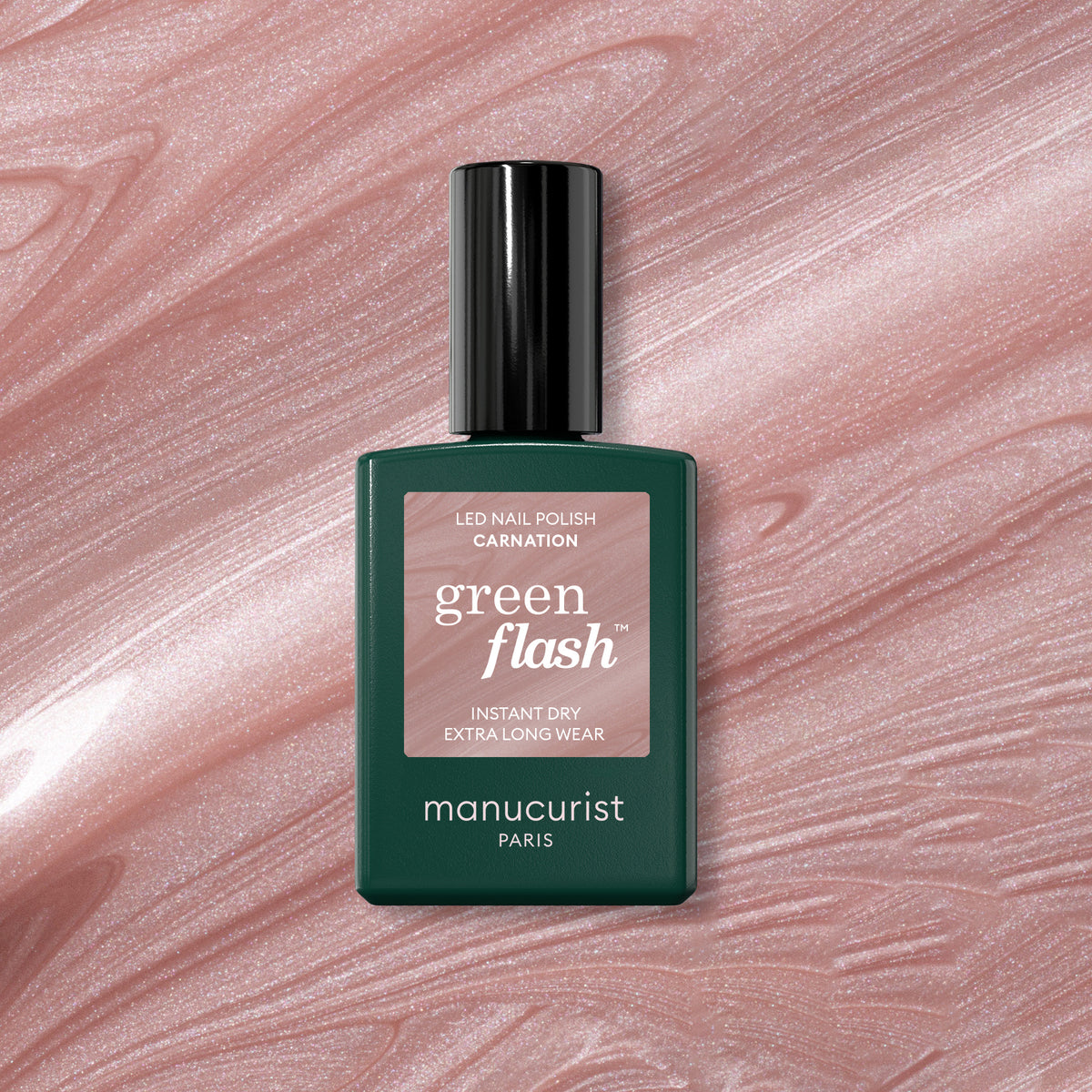 A bottle of Manucurist Carnation Green Flash gel polish is displayed on a pearly pink, shimmery marbled surface resembling nail polish.